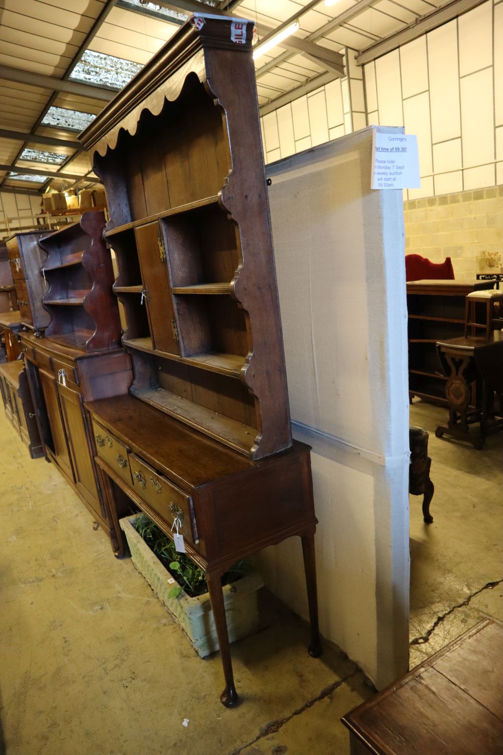 An 18th century oak low dresser with later boarded plate rack, width 128cm depth 46cm height 216cm